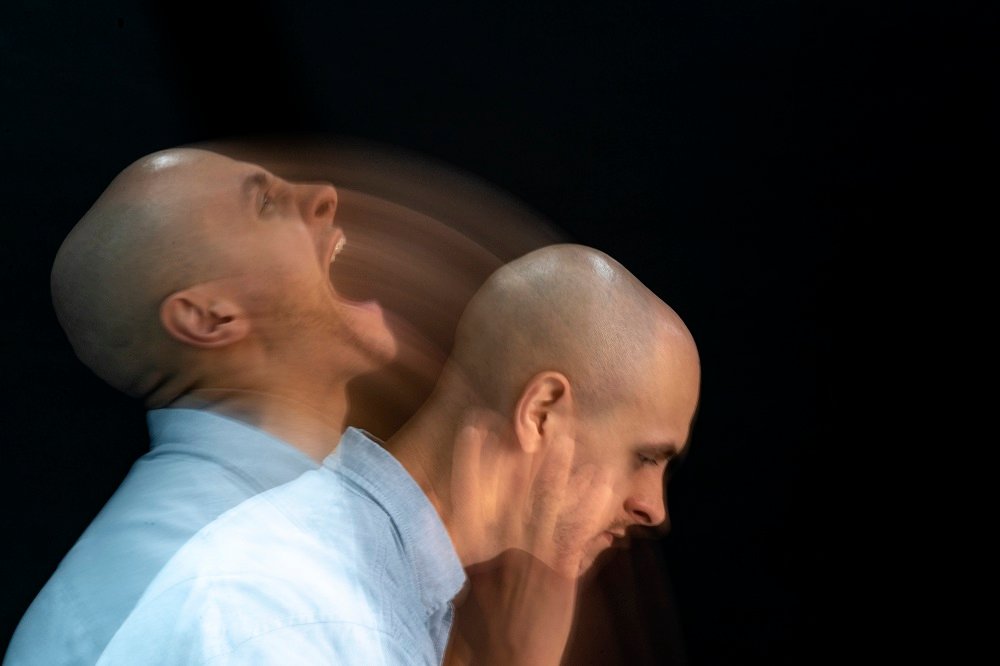 A man showing a blurred expression of frustration or pain, with one image capturing him shouting and the other showing a more subdued, pained posture.